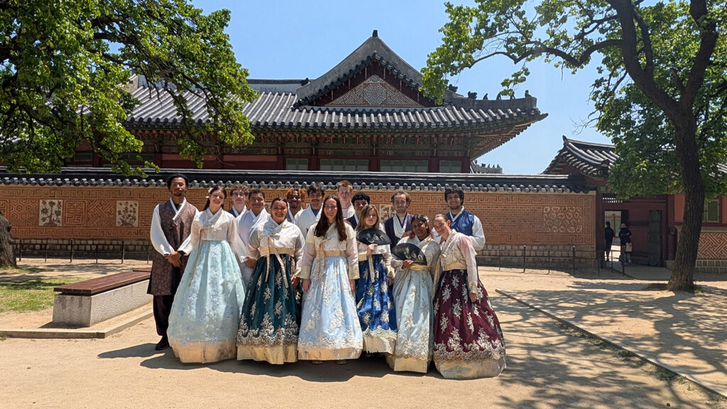 Students in traditional clothing posing for a photo