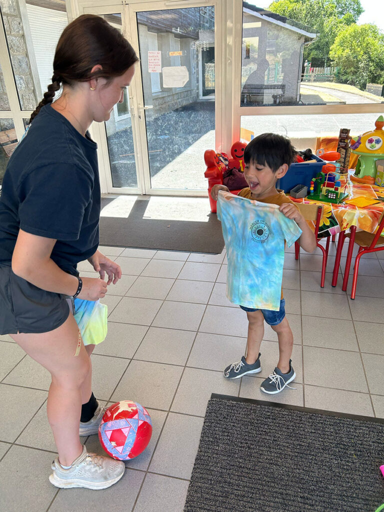 Child holding a custom t-shirt