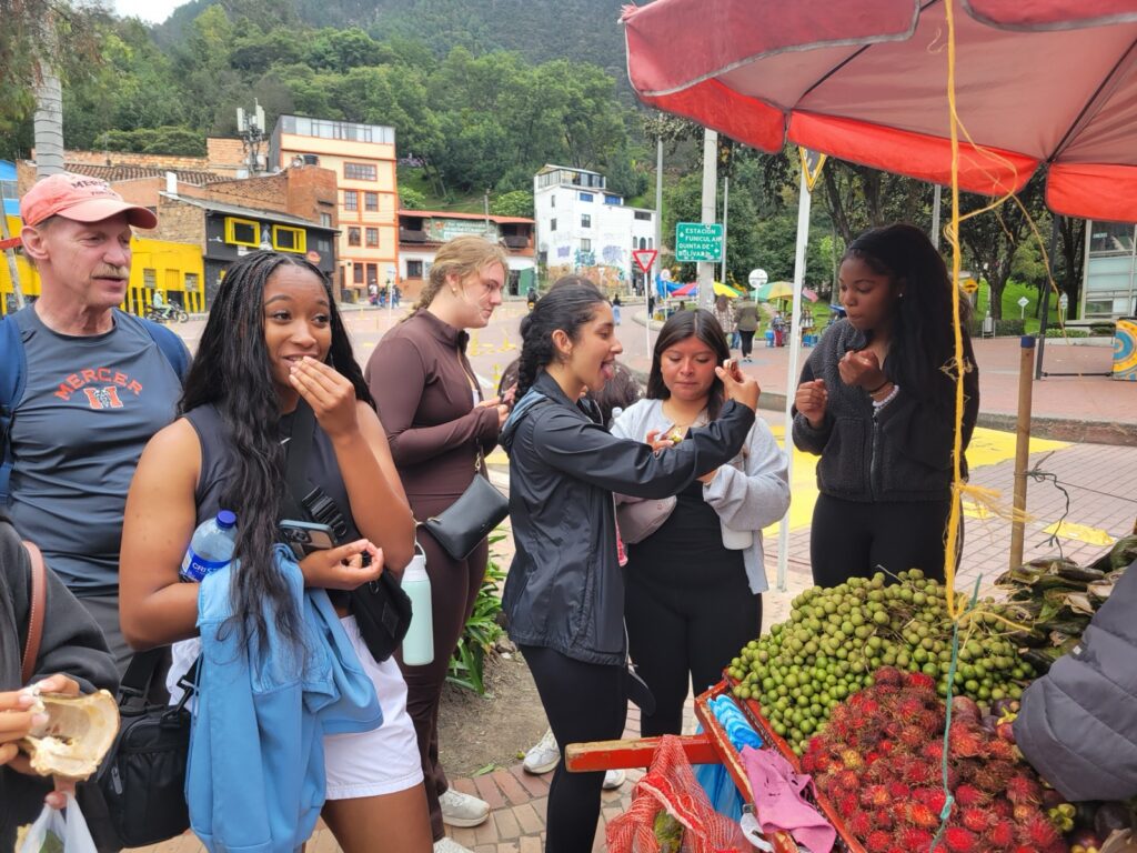 Students sampling produce at a stand