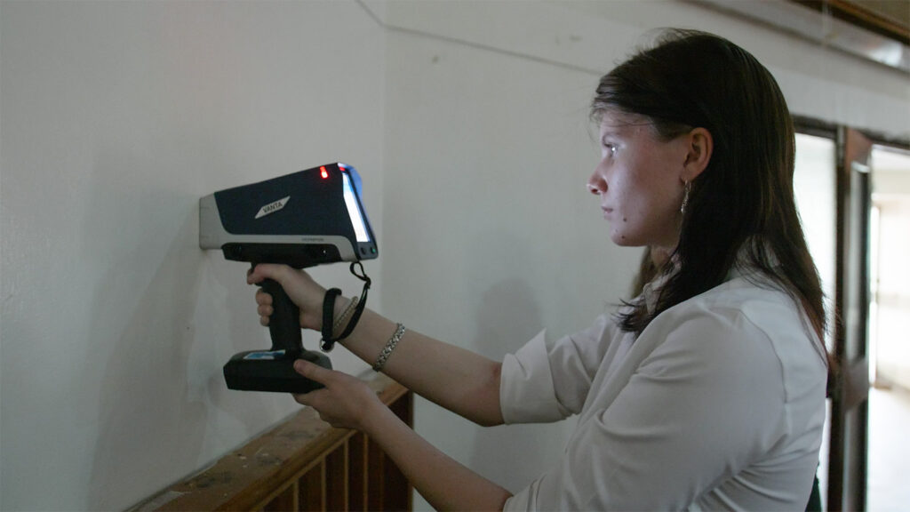 Student uses a device to measure lead amounts in paint