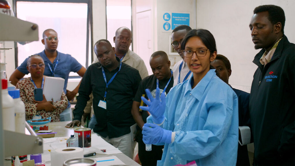 Students testing paint in a lab