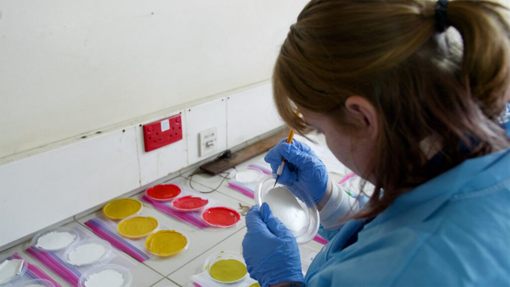 Students testing paint in a lab